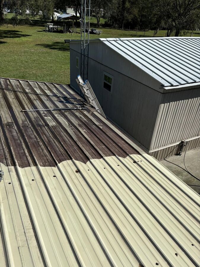 Standing seam metal roof cleaning showing dirt and stains lifted from the panel